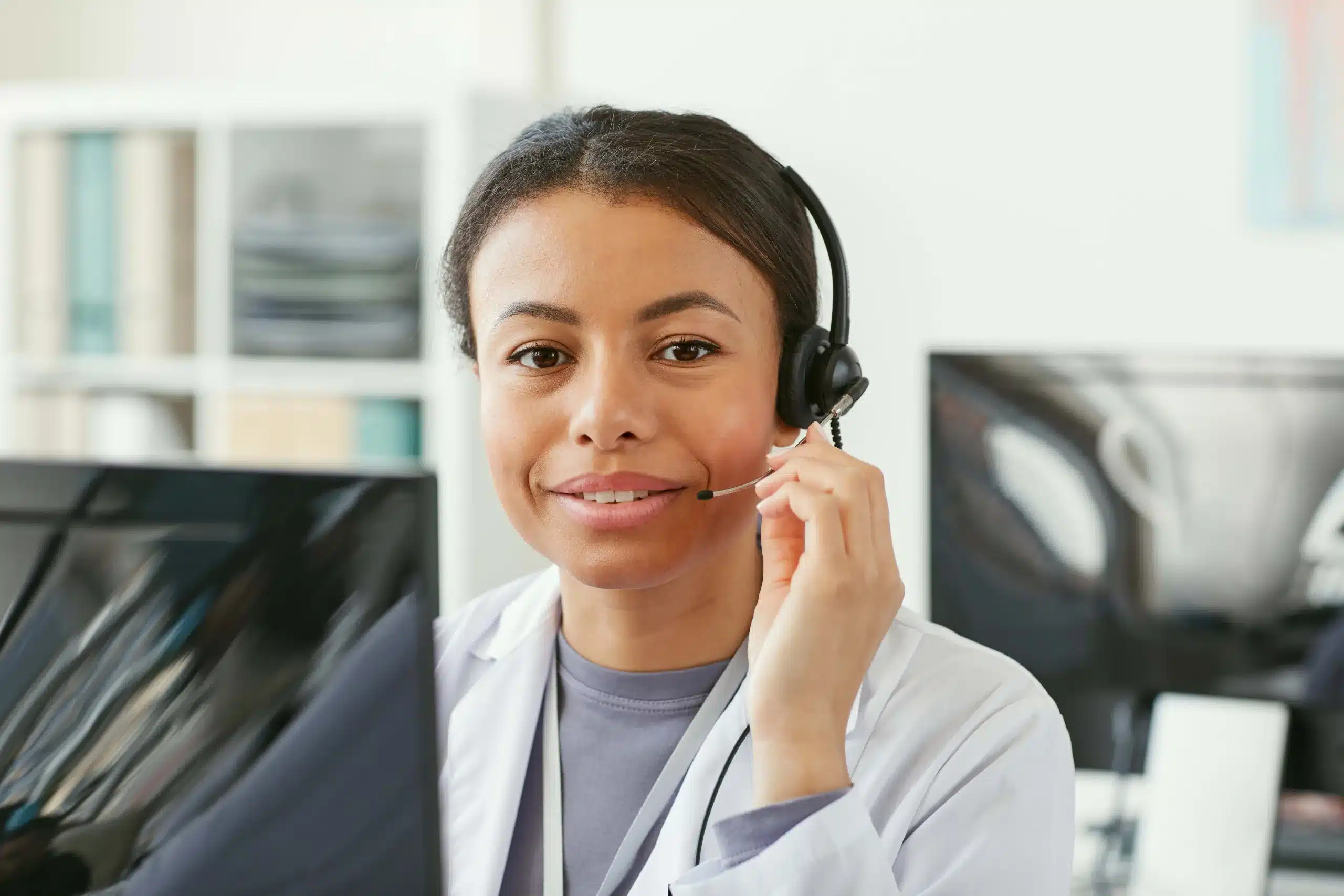 Medical answering service receptionist at her desk